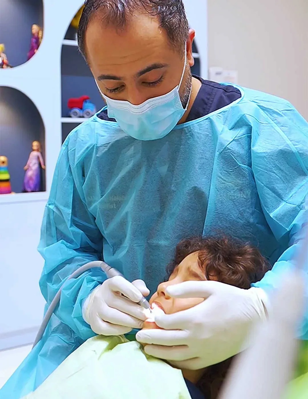 Dr. M Nour AlHalabi, Head of Pediatric Dentistry at Harmony Medical Center, applying dental sealants on a young male patient.