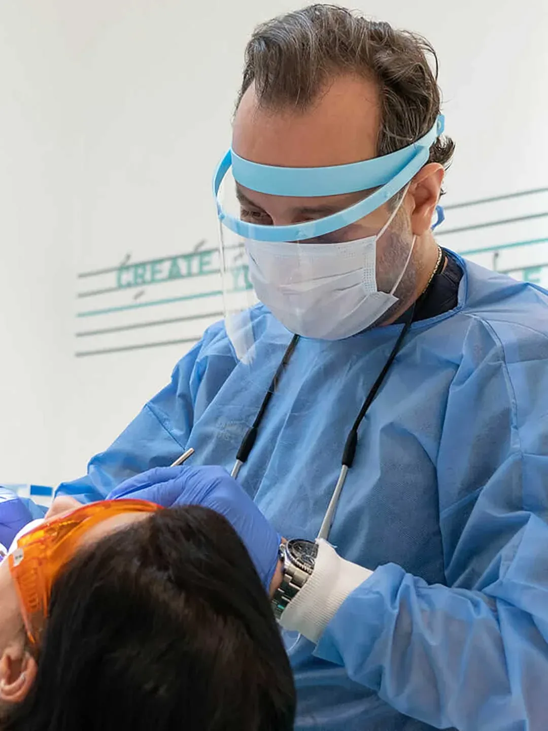 One of Harmony Medical Center’s dentists performing a dental checkup during a patient’s first visit.